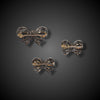 Three antique French bow brooches in original case
